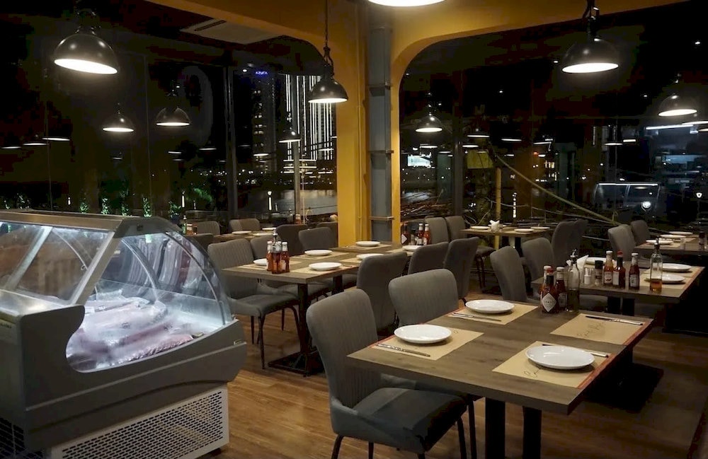 The restaurant offers a modern, relaxed atmosphere with soft lighting and gentle music
